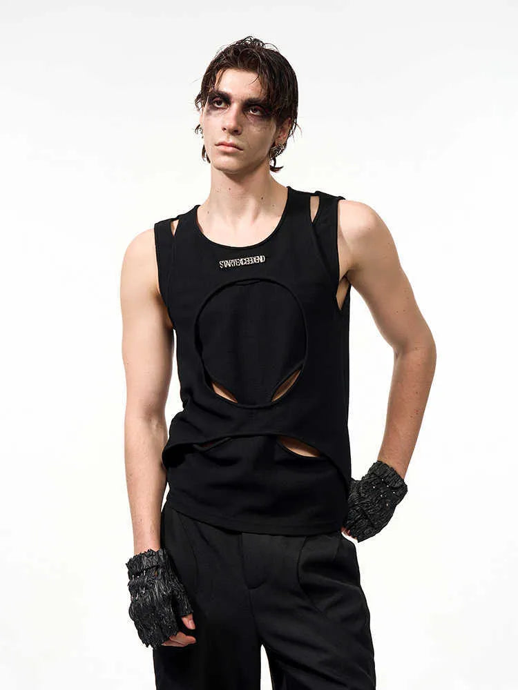Man wearing a loose-fitting black sleeveless vest with a round neck, showcasing the hollow-knit fabric texture.