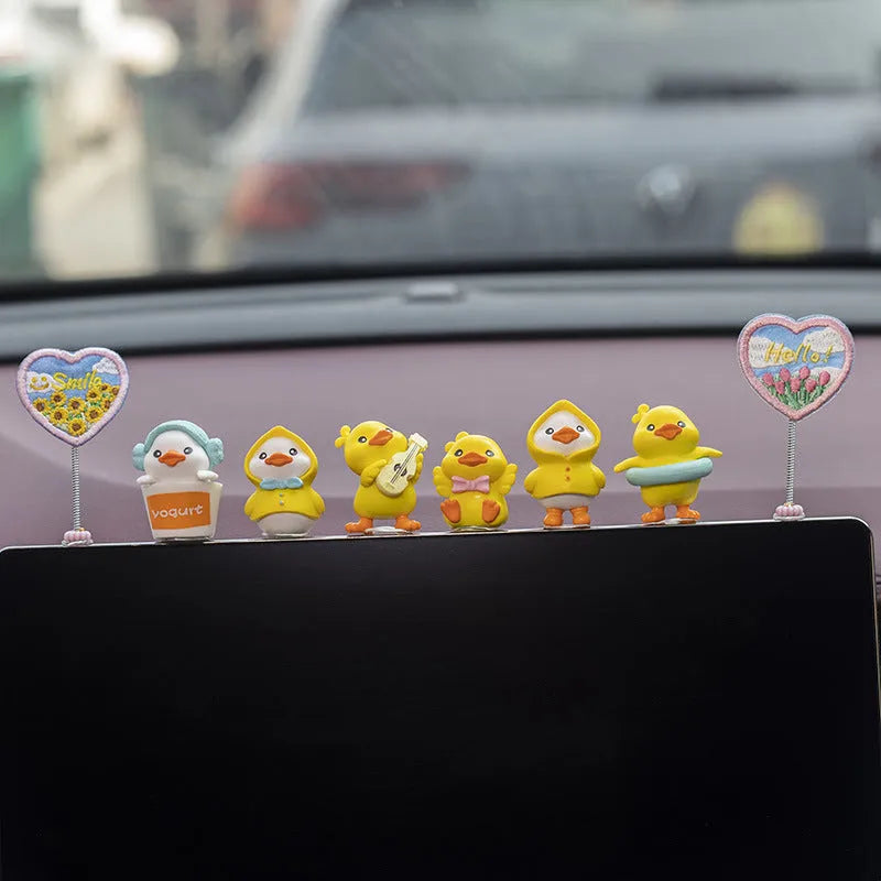 Set of six small PVC cartoon duckling car decorations with hello sign on car dashboard