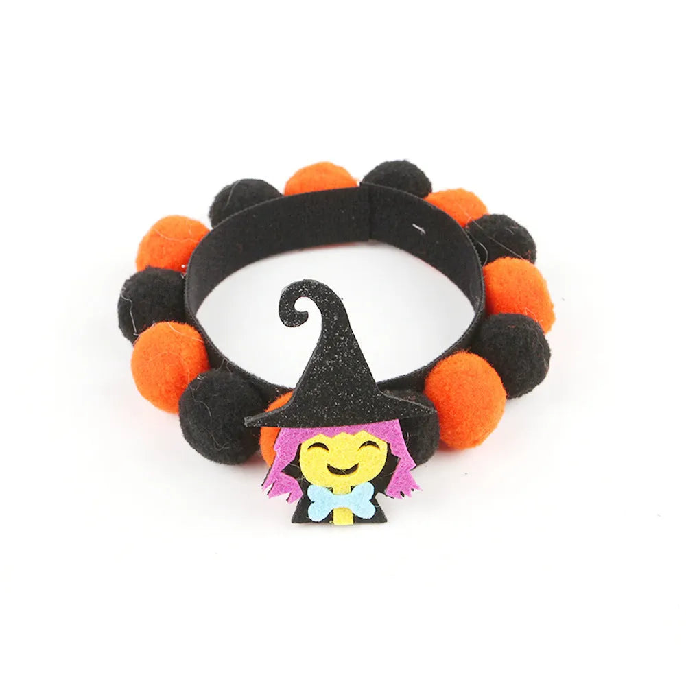 Halloween pet collar with fur ball decoration in pumpkin design on dog neck