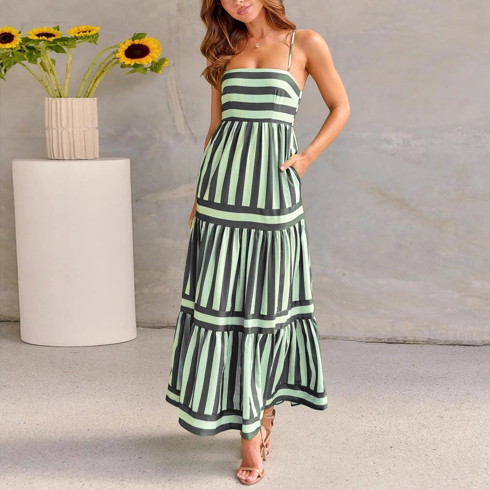Long striped backless summer dress with square neckline and side pockets on a mannequin