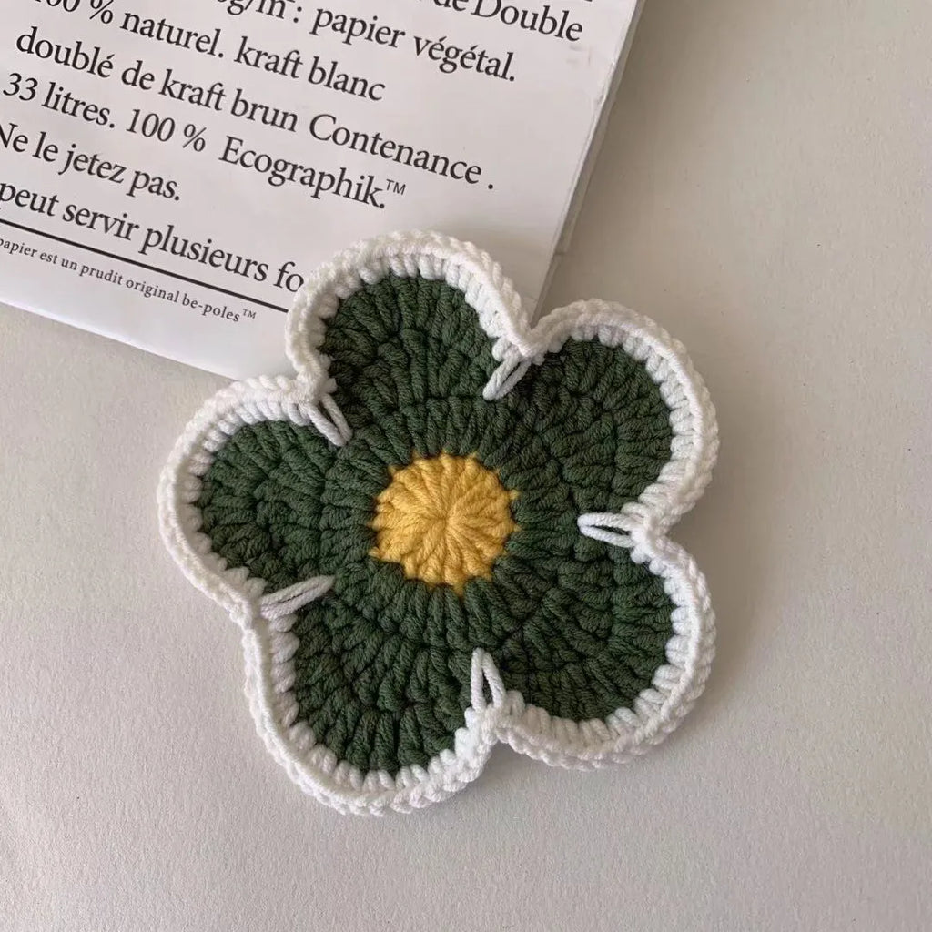 Colourful handmade cotton thread woven flower placemats on dining table