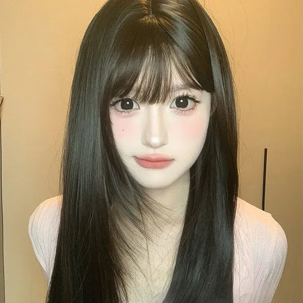 A dark brown long straight synthetic wig with a fringe on a wig stand.