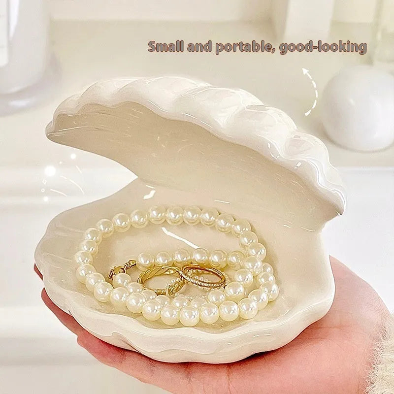 White porcelain storage tray with optional small night light, shown in pink and white shell colours on a wooden surface.