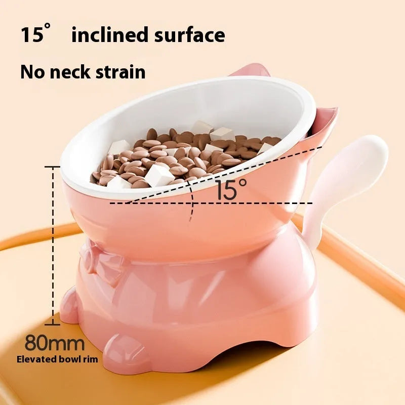 A tilted stainless steel cat bowl in blue, showing its 15-degree angle and weighted non-slip base on a kitchen floor.