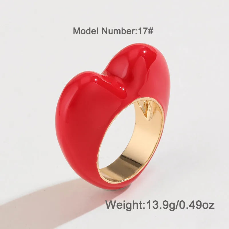 Heart-shaped zinc alloy enamel ring with three-dimensional colour detail in black, pink, purple, or red.