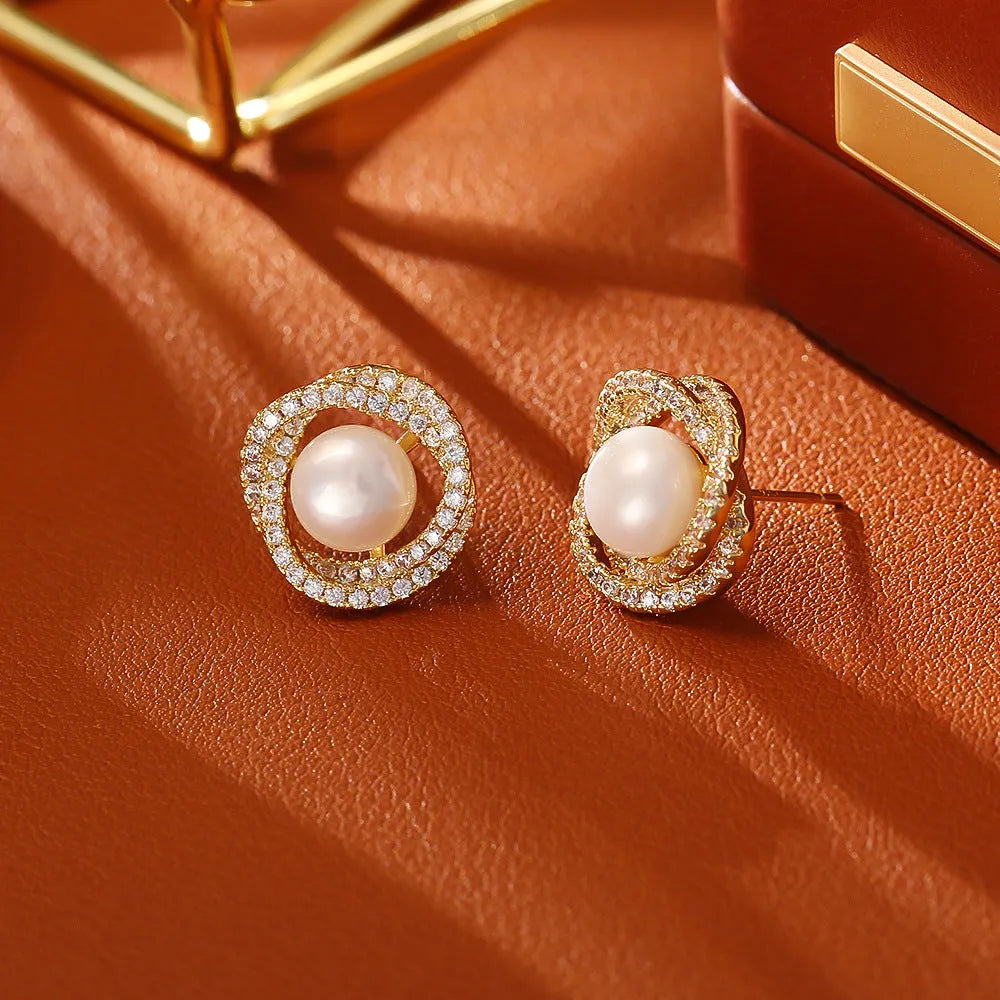 Natural pearl winding ear studs with real gold plating on copper base, geometric round shape