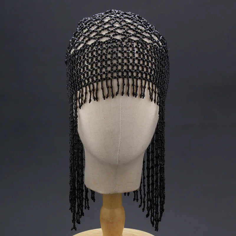 Silver belly dance hat with beaded tassels on black background for performance hair ornament