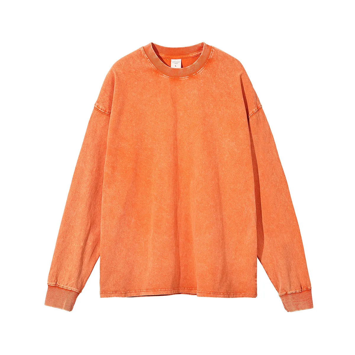 Man wearing a loose-fit batik print long sleeve cotton pullover top in a vintage washed colour.