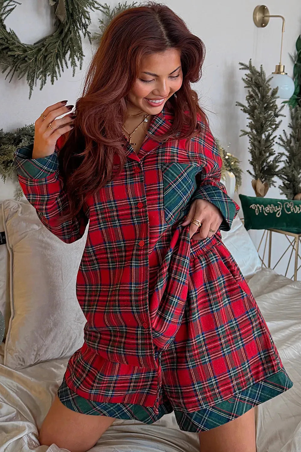 Red plaid Christmas pyjama set with contrast patches on shirt and shorts, laid flat.
