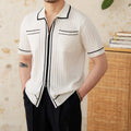 Slim fit black lapel polo shirt with short sleeves on a hanger.