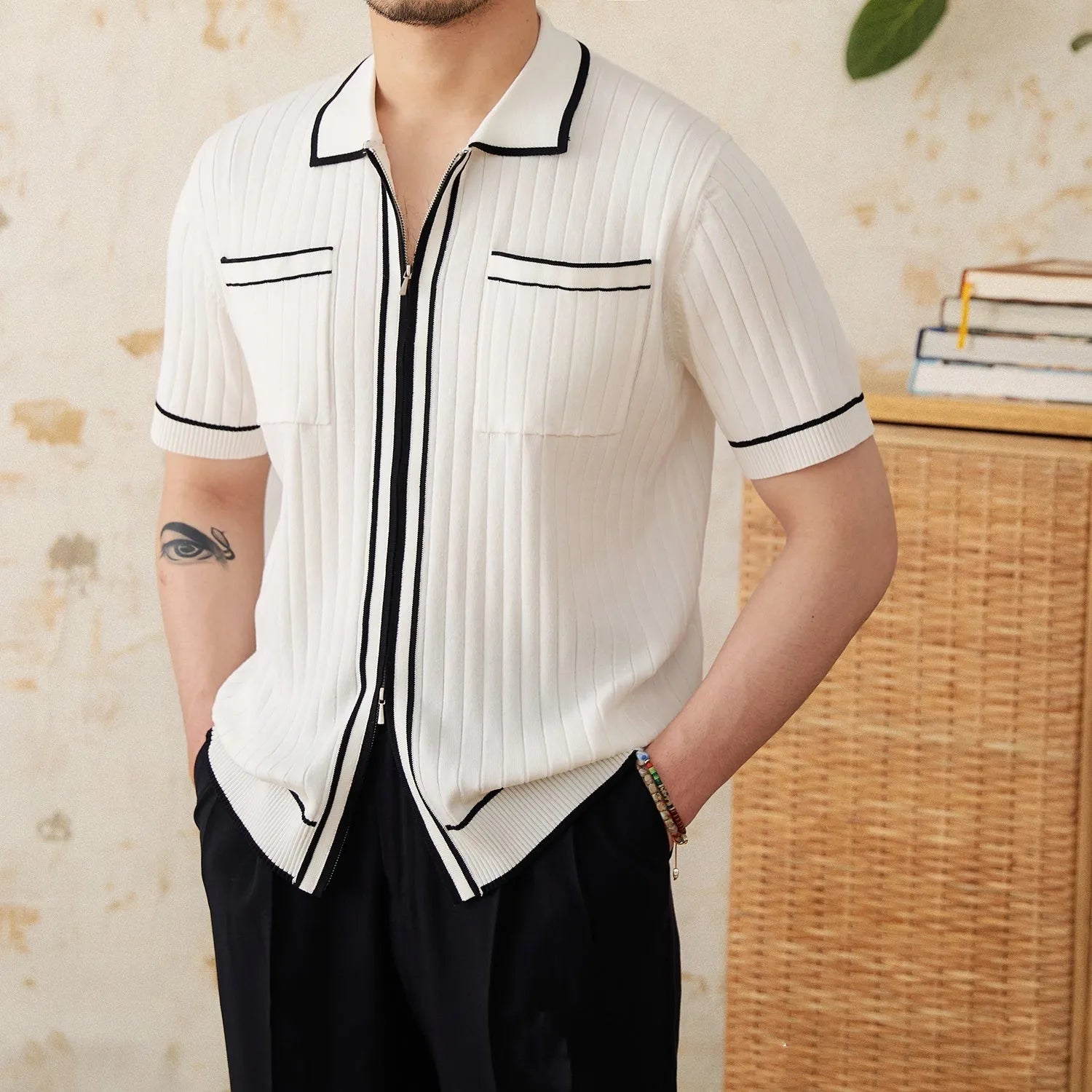 Slim fit black lapel polo shirt with short sleeves on a hanger.