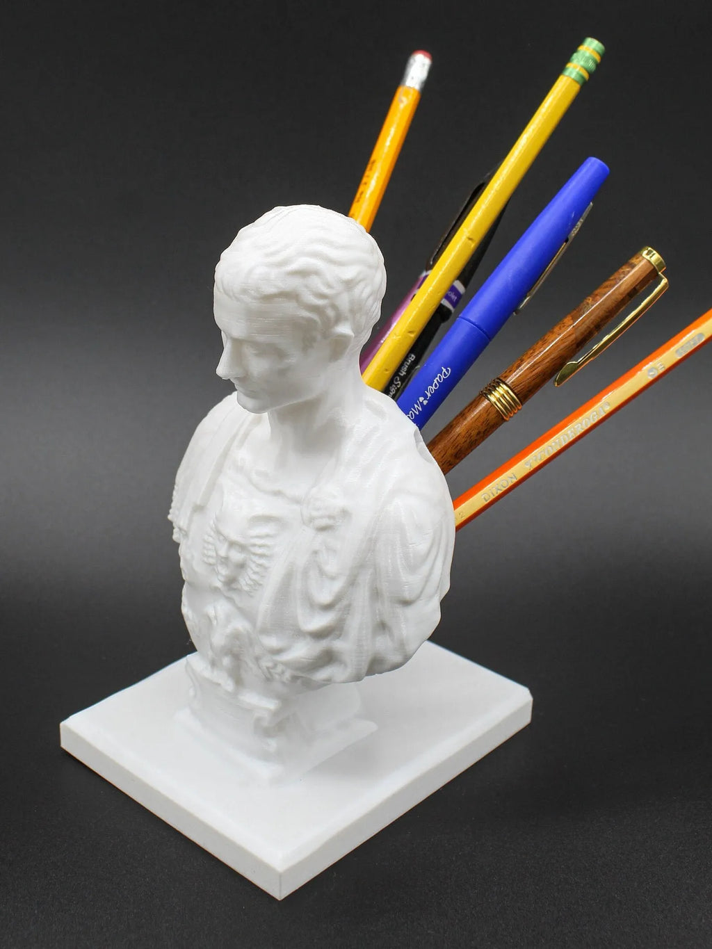 White synthetic resin pen holder with American creative character design for desk organisation.