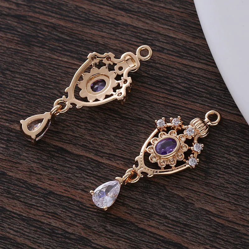 Micro inlaid zircon crown hollow water drop-shaped copper pendant in electroplated colour.