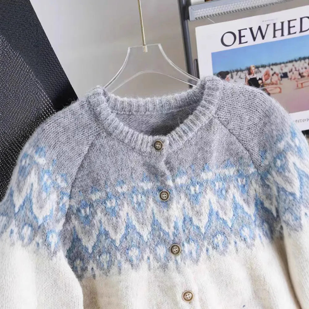 Women's loose fit jacquard knit sweater coat in contrast colours, showing long sleeves and textured pattern.