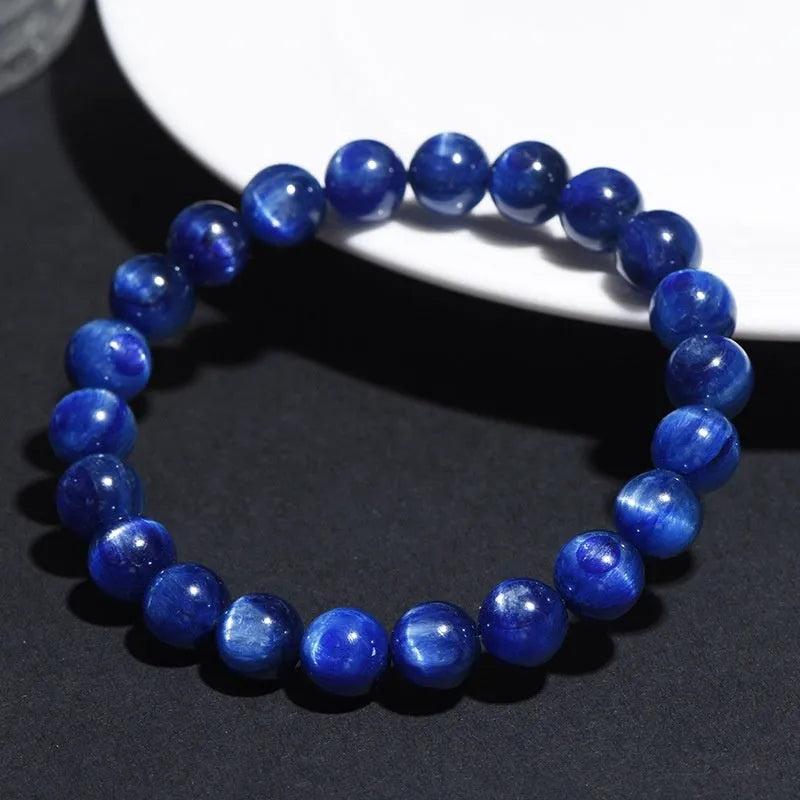 Natural blue crystal ball bracelet with geometric shape and Ruyi design on a white background.