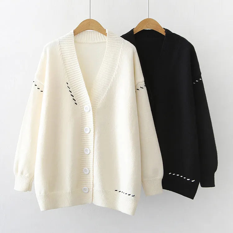 Women's loose-fit knitted cardigan coat in black or white.