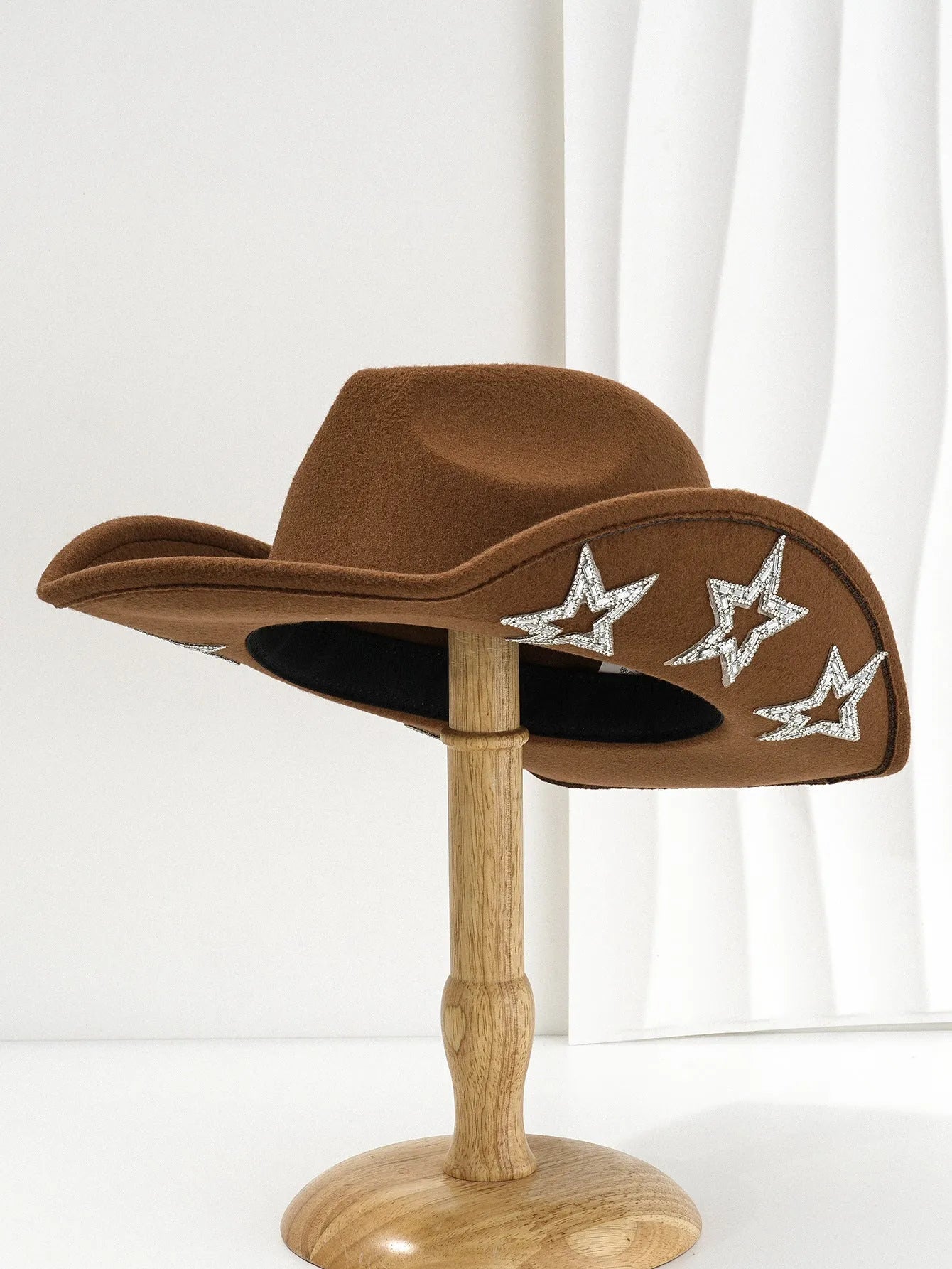 Beige woven polyester western top hat with a conical crown and a hexagonal star decoration on the front.