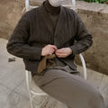 Coffee brown loose fit acrylic cardigan with long sleeves on a plain background