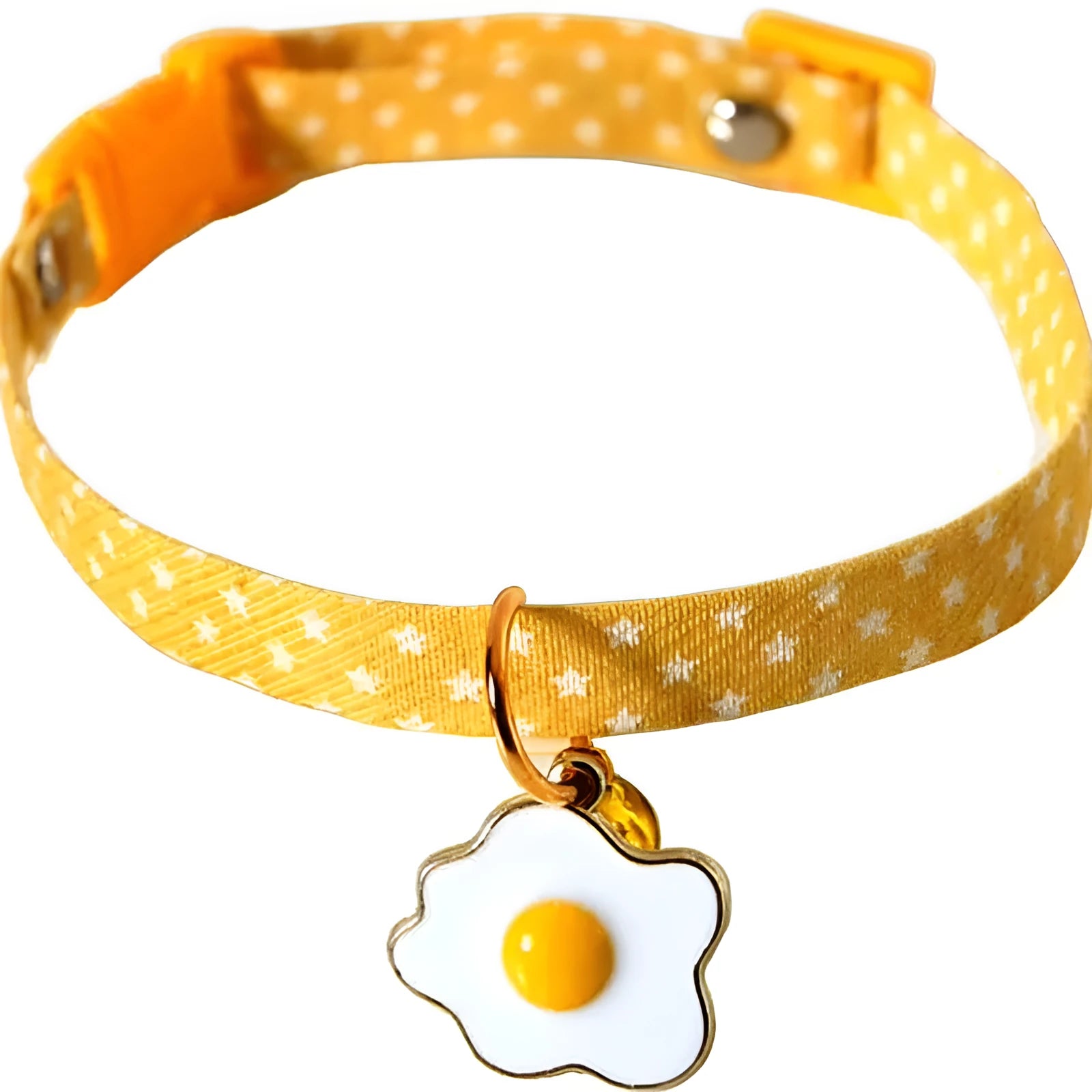 Adjustable green cat collar with a metal bell and a red bow tie pendant fastened around a small dog's neck.