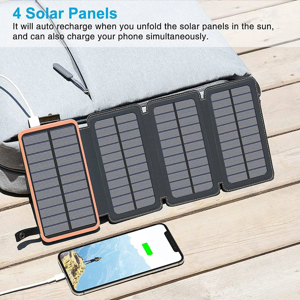Outdoor solar power bank in black with a solar panel, soft leather finish, and LED light on a grassy field.