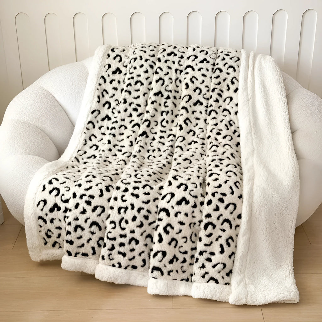 Double-layer cationic leopard jacquard taffeta blanket showing reversible design with zebra pattern
