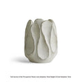 Irregular shaped ceramic art vase for flower arrangements on a desktop.