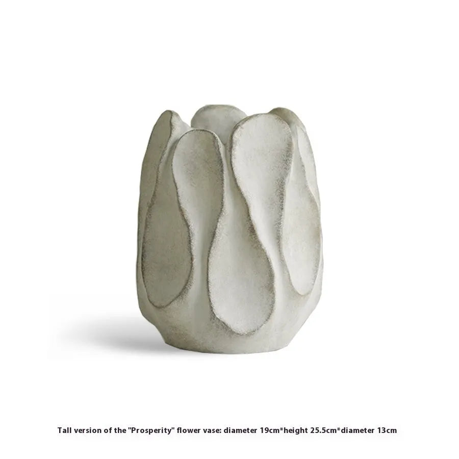Irregular shaped ceramic art vase for flower arrangements on a desktop.