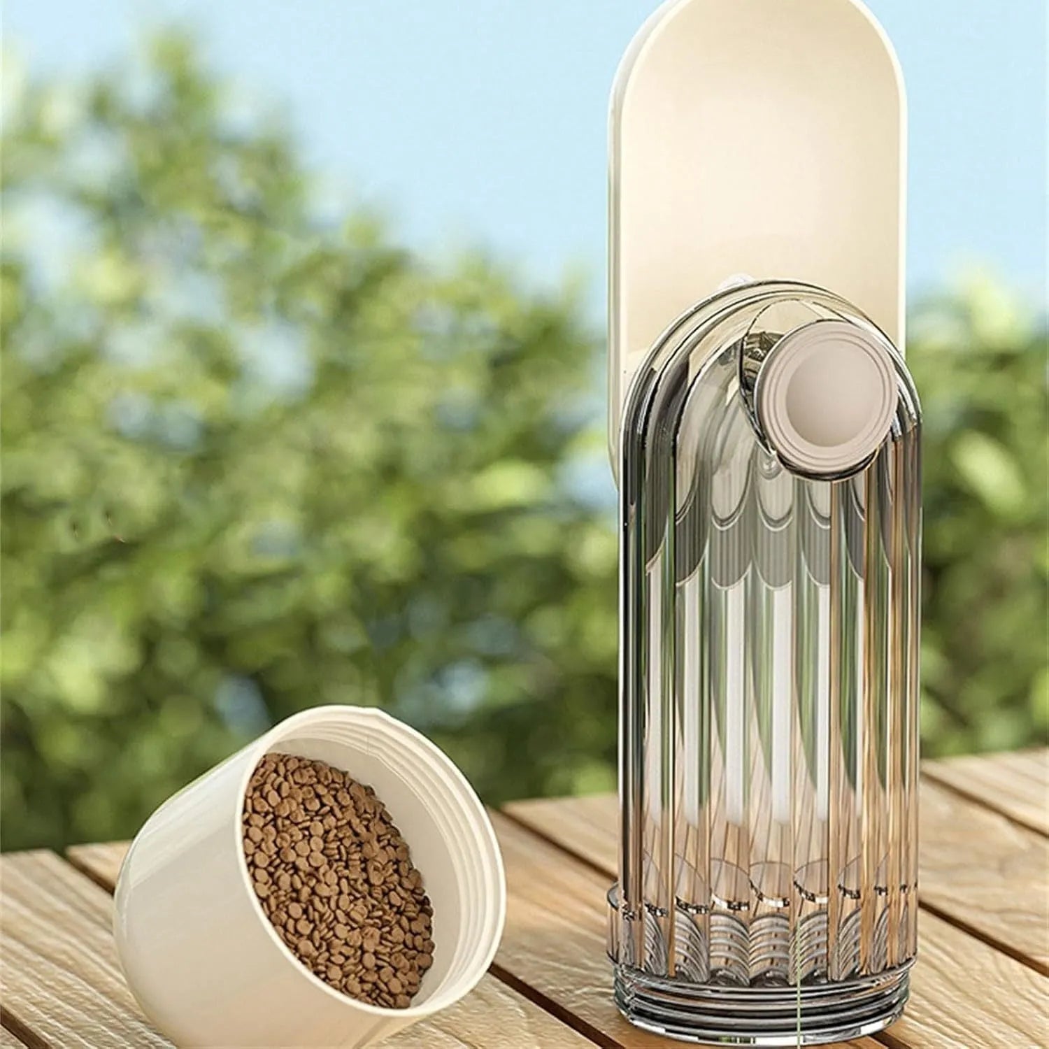 Beige foldable dog water bottle with food dispenser base shown extended and compressed