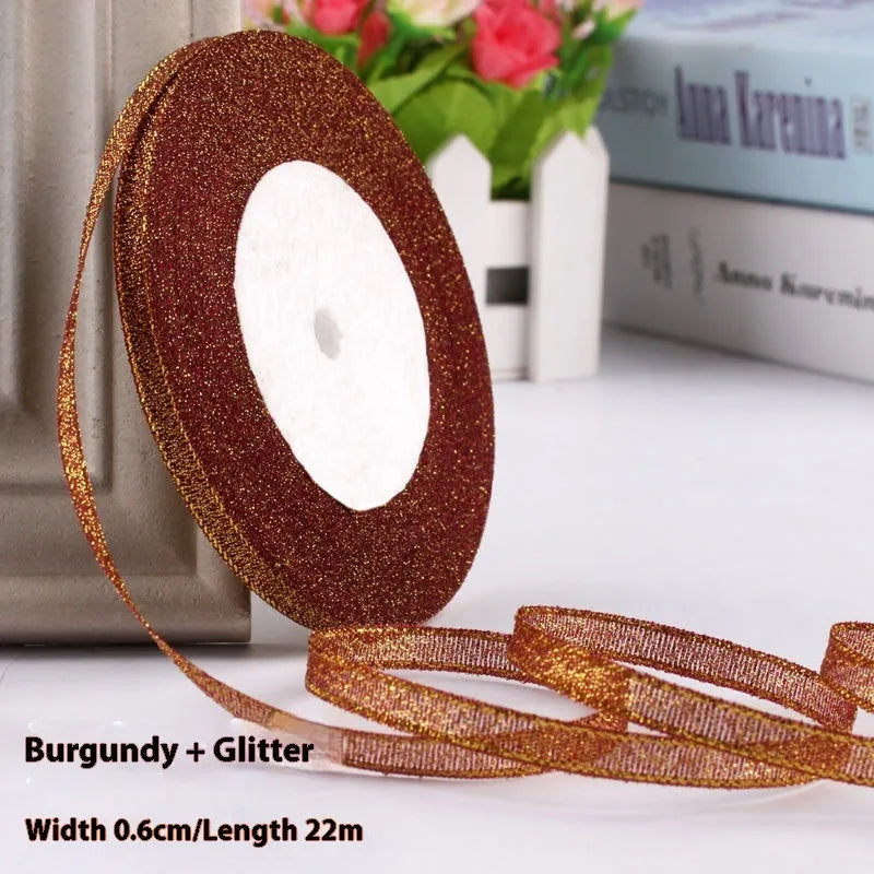 Roll of narrow 0.6cm wide polyester gift ribbon in a multicolour pattern.