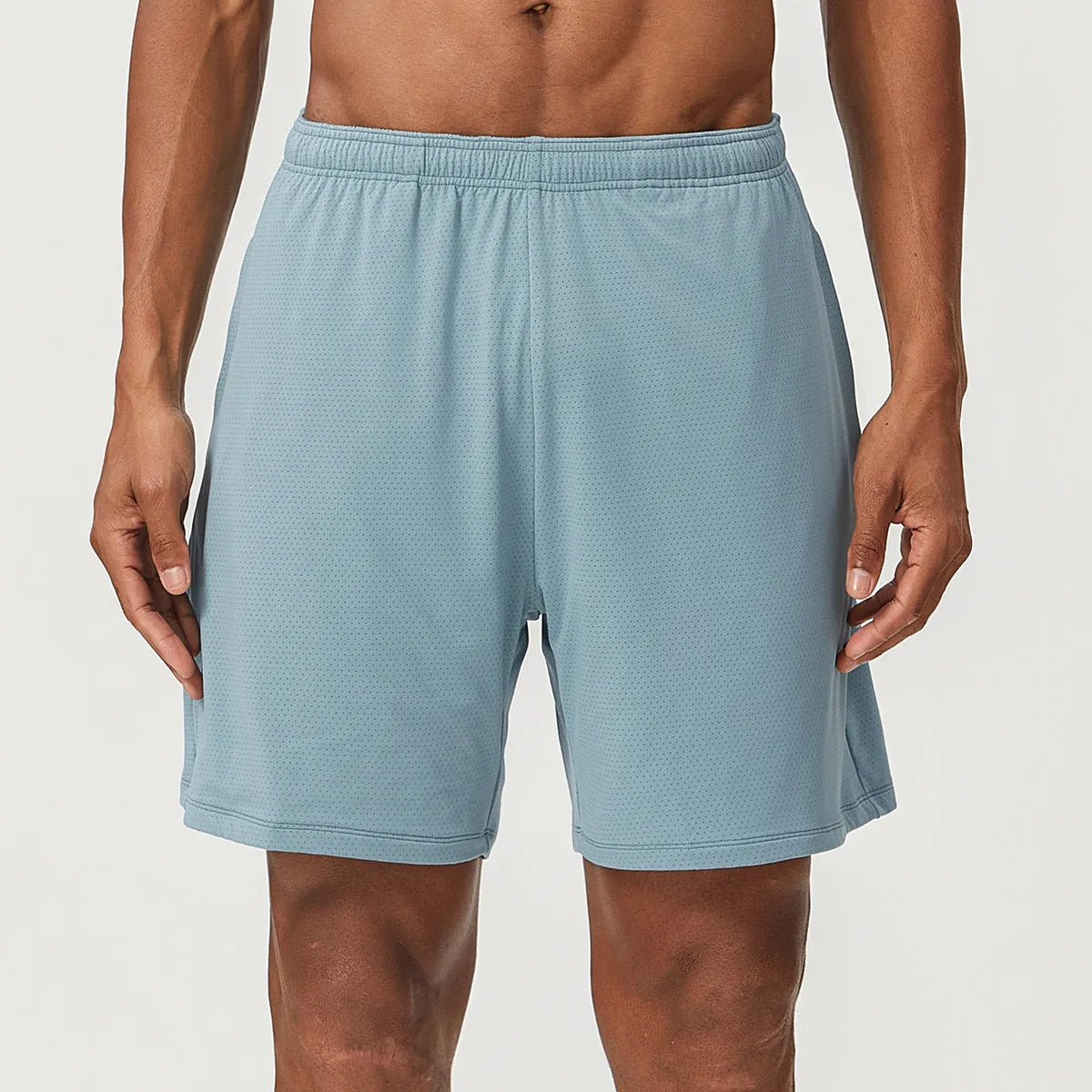 Men's quick-dry double-layer running shorts in a brick red colour on a mid-waist fit model.