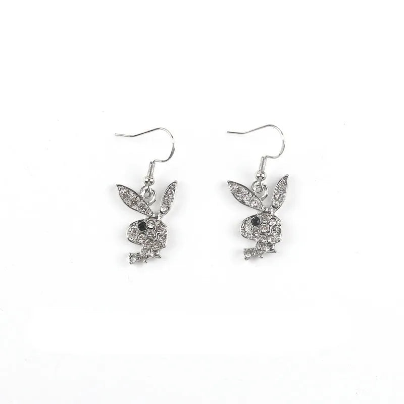 Close-up of rabbit-shaped stud earrings with sparkling cubic zirconia stones in gold, pink, and silver finishes.