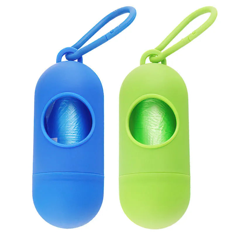 Black plastic dog poop bag dispenser with Velcro strap and a side metal hook.