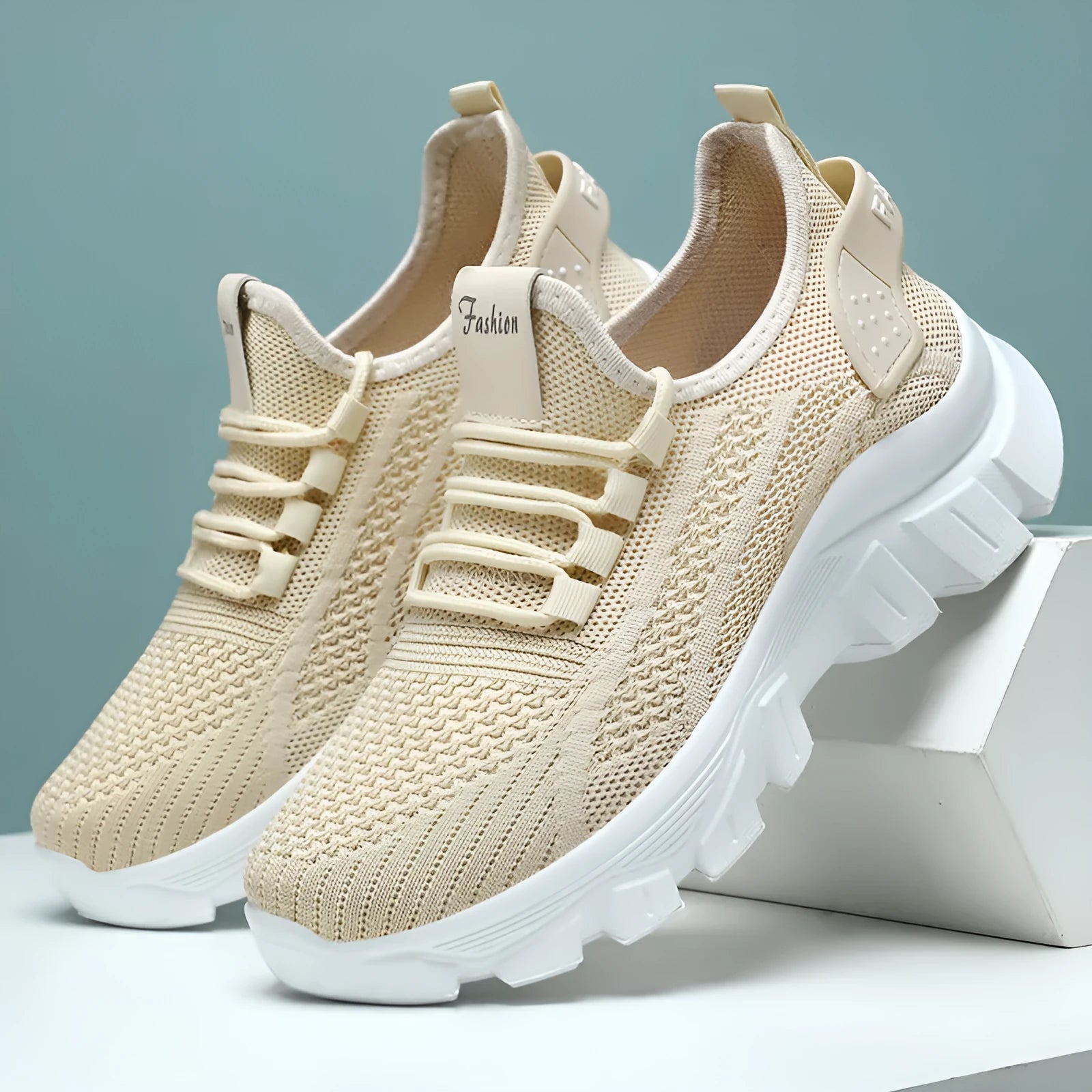 Women's white Flyknit sneakers with thick PVC sole and lace-up front on a neutral background.