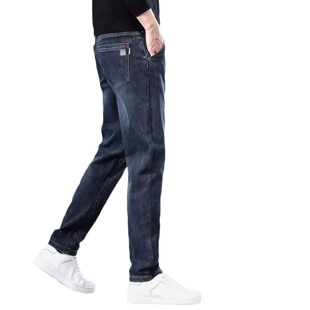 Man wearing blue-grey slim straight loose fit casual trousers with a micro-elastic waist.
