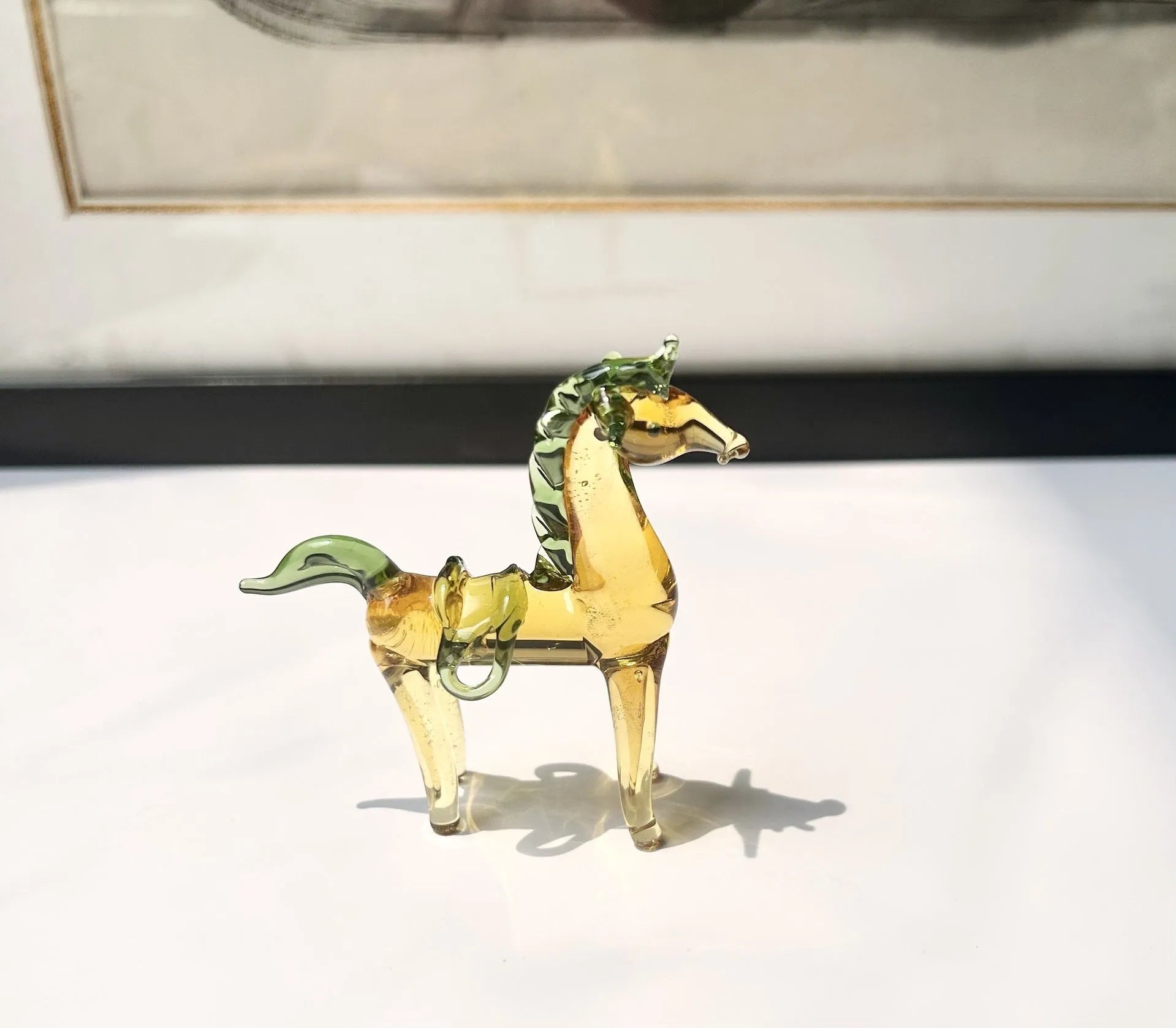 A smooth glazed horse figurine ornament in a modern minimalist style on a table.