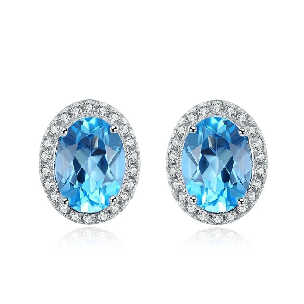 925 sterling silver blue topaz geometric jewellery set showing necklace, earrings, ring, and pendant