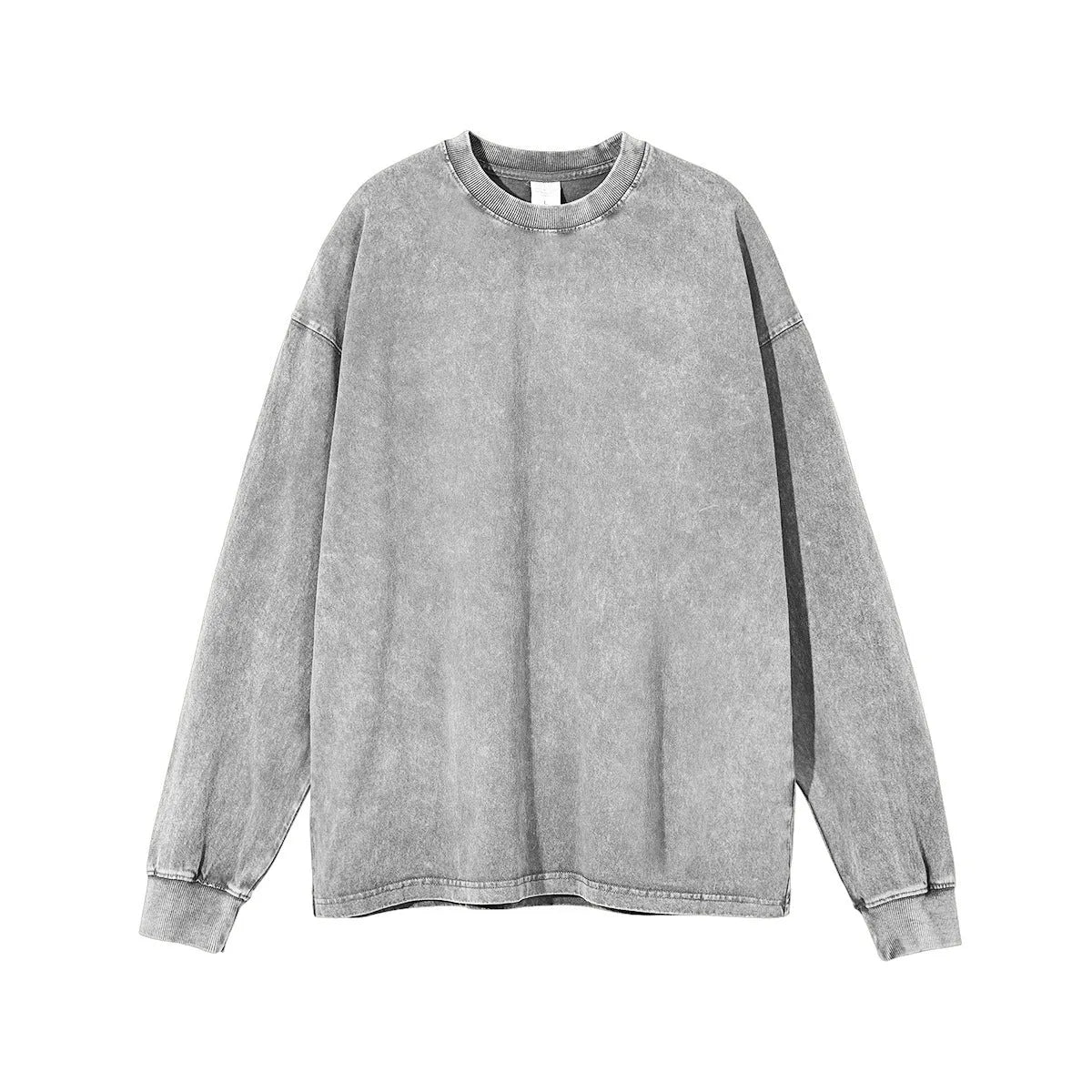 Man wearing a loose-fit batik print long sleeve cotton pullover top in a vintage washed colour.