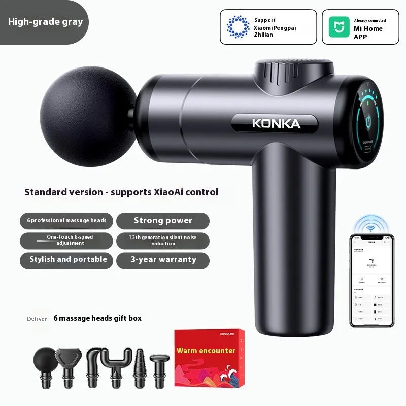 Konka V19 grey massage gun with multiple silicone attachment heads on a table.