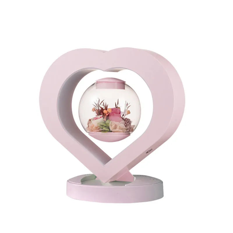 Pink preserved rose ornament with LED lights on a base, with optional audio Bluetooth for music.