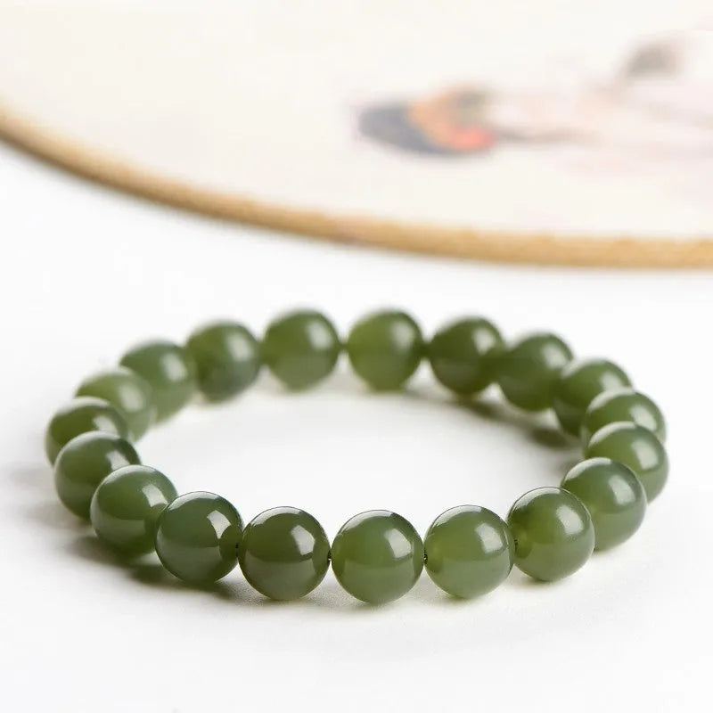 Polished Hetian jade ball bracelet on wrist, showing ice-like clear beads in available 4mm, 6mm, 8mm, and 10mm sizes.