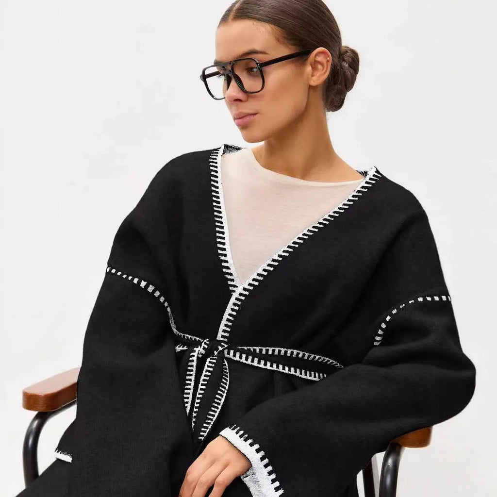 Lace-up front knitted cardigan in black, camel, or white, showing loose fit and thick fabric.