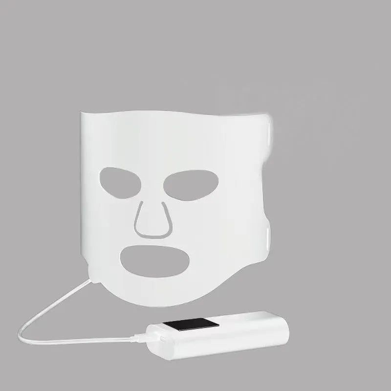 Black and white LED light therapy face mask with controller for home skin treatment.
