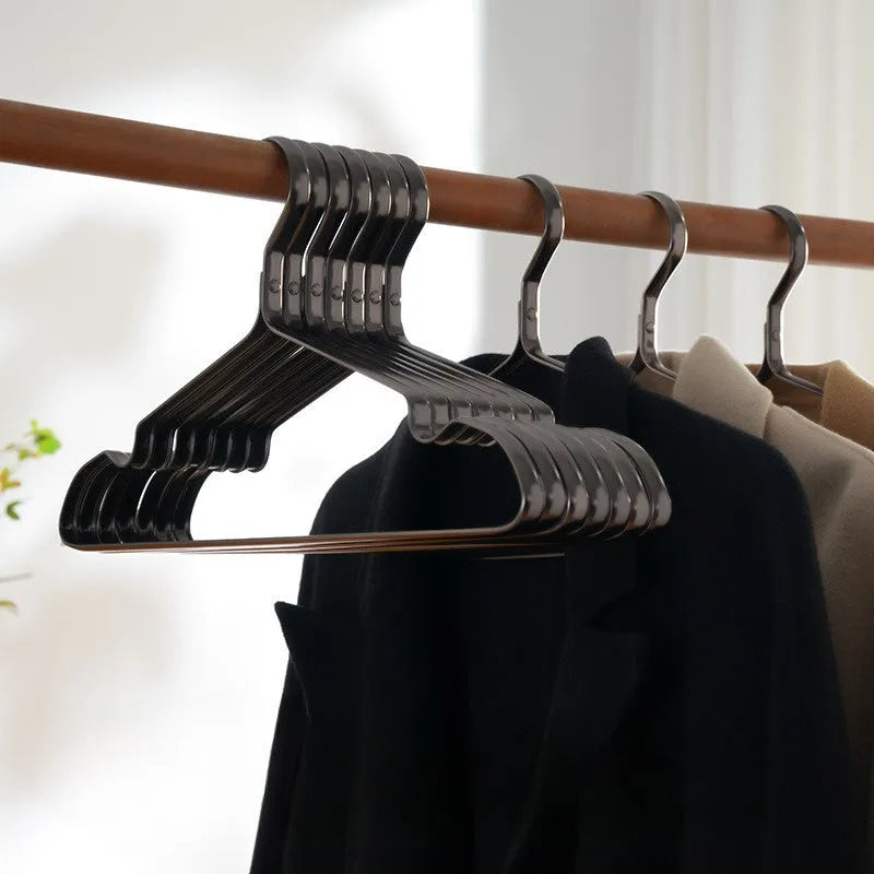 Elegant black non-slip metal clothes hanger for suits and trousers.