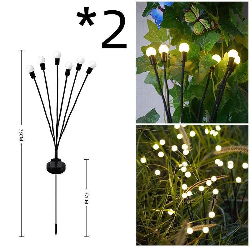 Solar-powered LED firefly garden spike light with multiple heads and a press-in ground plug on grass.