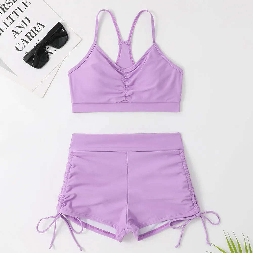 Purple and black women's high-waisted split bikini swimsuit on a mannequin.