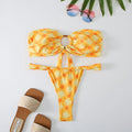 Women's floral print tube top ring bikini set with briefs on a white background.