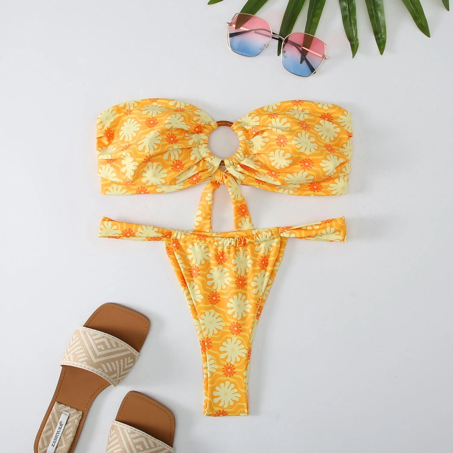 Women's floral print tube top ring bikini set with briefs on a white background.
