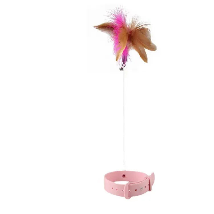 Pink and blue adjustable collar cat teaser toy with feather and bell attachment on a white background