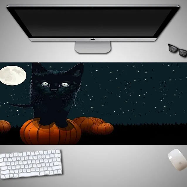 Large Halloween patterned gaming mouse pad on a desk showing non-slip rubber base and extra-long design.