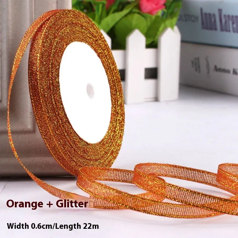 Roll of narrow 0.6cm wide polyester gift ribbon in a multicolour pattern.